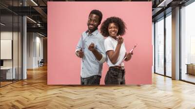 Two african students with folders in t-shirts together. Stylish girl with Afro hairstyle and her boyfriend. Wall mural