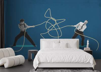 Two men tugging opposite ends of tangled rope, symbolizing tension and competition in business, collaboration to untangle a complex situation. Contemporary art collage. Concept of business, progress Wall mural