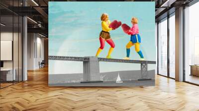 Two middle-aged sportive women in colorful sportswear fighting with raspberry gloves on bridge over the river. Contemporary art collage. Concept of surrealism, travelling, imagination Wall mural