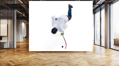 Unrecognizable male hockey player with the stick on ice court and white background. Sportsman wearing equipment and helmet practicing. Concept of sport, healthy lifestyle, motion, action. Top view. Wall mural