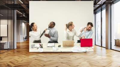 Winners. Young african and caucasian men and women sitting at office and working on laptops. The business, emotions, team, teamwork, workplace, leadership, meeting concept. different emotions of Wall mural