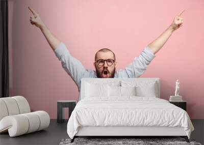 Winning success man happy ecstatic celebrating being a winner. Dynamic energetic image of male model Wall mural