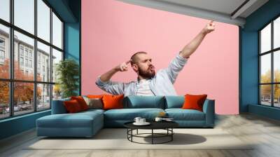 Winning success man happy ecstatic celebrating being a winner. Dynamic energetic image of male model Wall mural