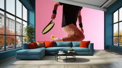 Young caucasian man playing tennis isolated on pink studio background, action and motion concept Wall mural