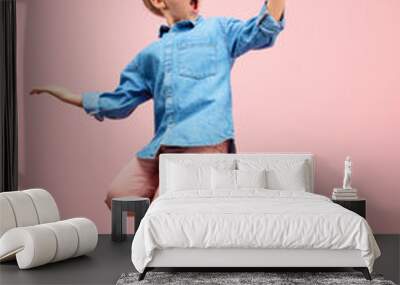 Young happy surprised caucasian teen girl jumping with mobile phone in the air, isolated on pink studio background. Beautiful female full length portrait. Human emotions, facial expression concept. Wall mural