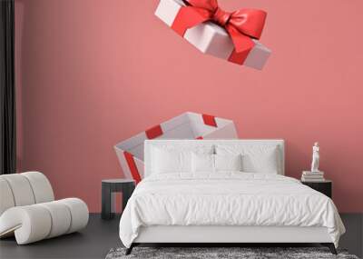 Blank open white gift box or present box with red ribbon bow isolated on light red pink orange pastel color background with shadow 3D rendering Wall mural