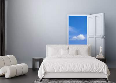 Opened door to blue sky with empty white wall background Wall mural