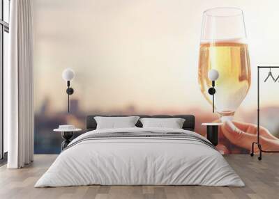 A glass with champagne or wine close-up on the blurred background of the urban area Wall mural