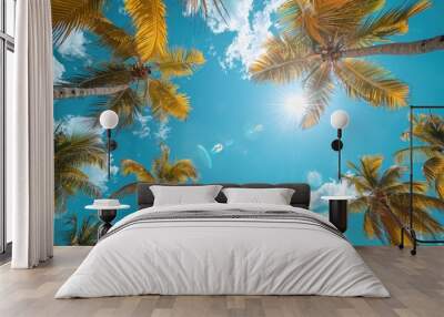 A sunny tropical background with palm trees and a blue sky. A view from below, Wall mural