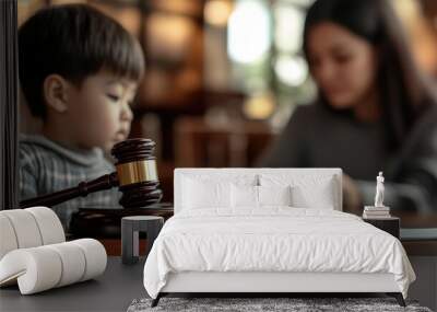 Cute child and mother at table with gavel of judge blurred in background, family law concept Wall mural