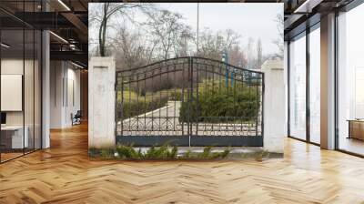 Reliable metal, forged gates protect the closed area from outsiders Wall mural