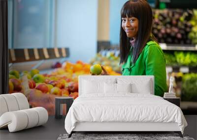 African American woman shopping for produce in grocery store Wall mural