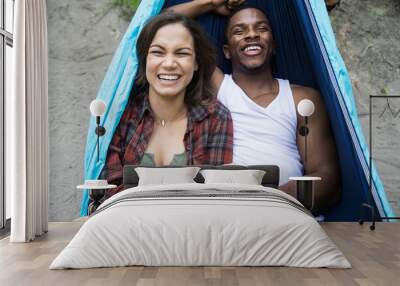 Mixed race couple laying down in hammock Wall mural