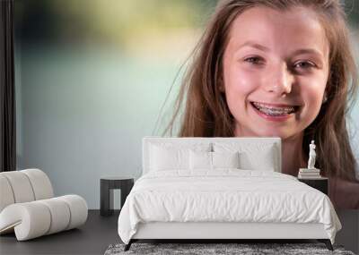 Teenage girl smiling with braces Wall mural