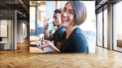 young couple laughing in cafe Wall mural