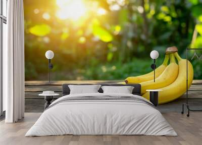 Raw organic bunch of bananas resting on a rustic wooden table with copy space. Natural sunlight. Tropical background.  Wall mural