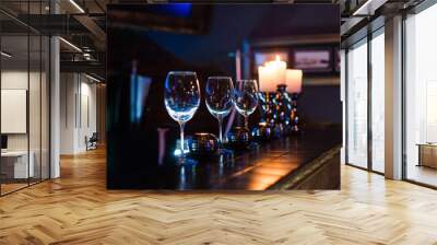 empty wine glasses and candles with illumination lights background. Romantic dinner dating night in bar or restaurant .  Wall mural