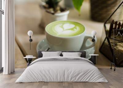 Green tea matcha latte art with succulent  cropped at an angle at a coffee shop cafe on wooden table  Wall mural