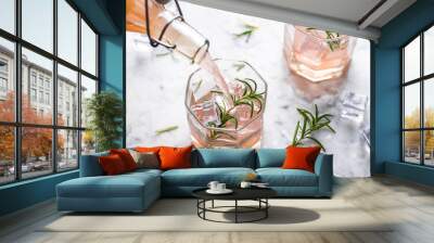 Pink grapefruit and rosemary drink, backlight on white background Wall mural