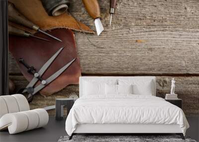 Leather craft tools on old wood table. Leather craft workshop. Wall mural