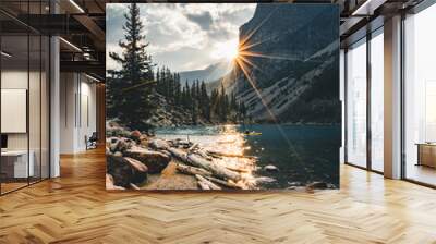 Sunrise with turquoise waters of the Moraine lake with sin lit rocky mountains in Banff National Park of Canada in Valley of the ten peaks. Wall mural