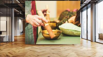 reiki session and sound harmonization with Tibetan bowls with hands giving relaxation to the woman in the zen space Wall mural