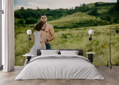 lifestyle . Man and a woman together outdoor. Kiss on the nature. Wall mural