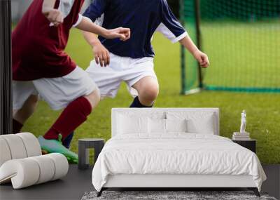 Children soccer game. Kids kicking soccer ball on a sports grass field. Children running after the ball Wall mural