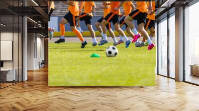 Football Club Training Session. Soccer Players on Daily Practice Unit. Athletes Running on Soccer Grass Field. Soccer Team Training Together Before League Competition Match Wall mural