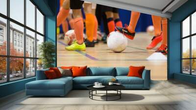 Football futsal training for children. Indoor soccer young player with a soccer ball in a sports hall. Sport background. Wall mural