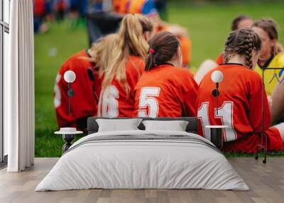 Girls in sports soccer team outdoors. Female physical education class on sports grass field. Young football players of female youth sports team Wall mural