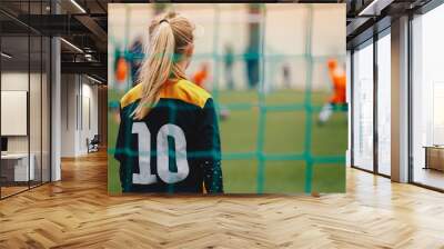 Soccer girl playing game as a goalie. Youth female football team playing tournament match Wall mural