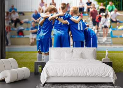 Young boys sports team on stadium. Football players in sportswear motivating before the match. Youth soccer tournament game for kids Wall mural