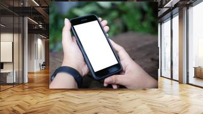 Mockup smartphone of man’s holding black mobile phone with white screen in his office. Wall mural