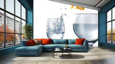 Gold fish jumping from a glass of water, to a larger one. Wall mural