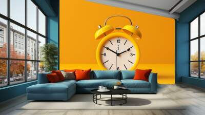 Yellow vintage alarm clock isolated on a yellow background Wall mural