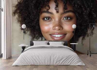 Close-up portrait of a African woman with curly hair and bright eyes Wall mural