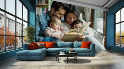 A Hispanic couple reads a book to their two young children on a sofa Wall mural