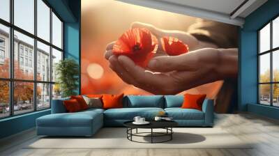 The Beauty of Nature: A Person Holding Two Vibrant Red Flowers in Their Hands Wall mural