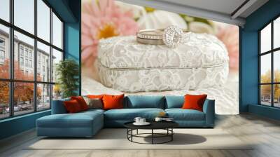 A beautiful engagement ring on an elegant lace-covered box, surrounded by flowers, symbolizing love and commitment. Wall mural