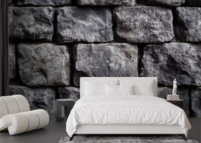 A close-up view of a textured stone wall made of irregularly shaped gray stones, showcasing natural materials and structure. Wall mural