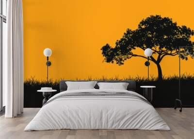 A striking silhouette of a lone tree against a warm orange sunset sky, with grass in the foreground Wall mural