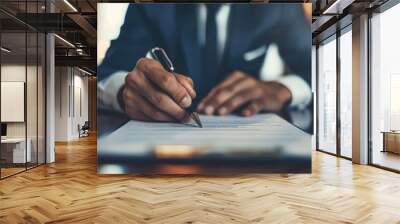 Businessman signing important documents at his desk. Wall mural