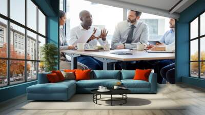 He explains things so well. Shot of a group of businesspeople having a meeting in a boardroom at work. Wall mural