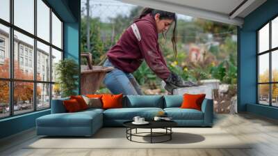 Focused Worker: Latina woman, gloves, concrete block, rural area.
 Wall mural