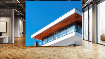 Striking modern building with wooden panels, white walls, on a crisp blue sky background Represents innovation, eco-friendliness and simplicity Wall mural