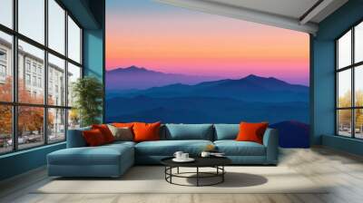 Stunning sunset view over layered mountain ranges in vibrant hues. Wall mural