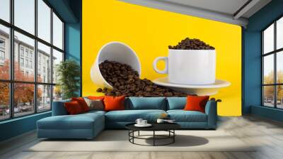 cup of coffee with coffee beans on yellow background Wall mural