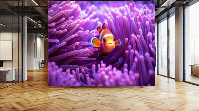 An underwater close-up of a colorful clownfish nestled among the tentacles of a sea anemone, showcasing their symbiotic relationship and stunning colors Wall mural