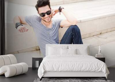 attractive man dressed casual posing outdoors Wall mural